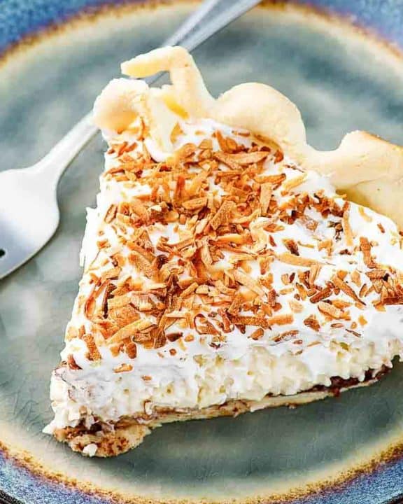 a slice of Bakers Square coconut cream pie on a blue plate