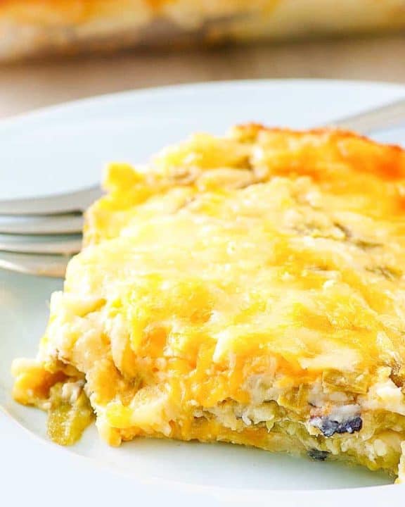 a slice of chili relleno casserole and a fork on a plate