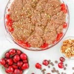 chocolate cherry cobbler with cherries, chocolate chips, and nuts beside it