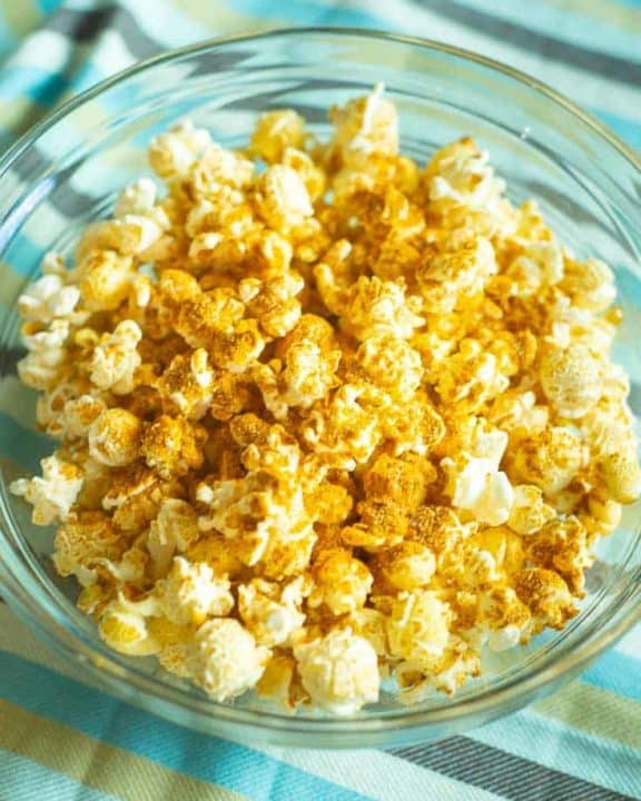 curry popcorn in a glass bowl