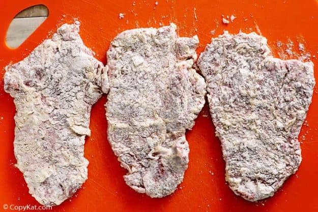 three breaded chopped steaks