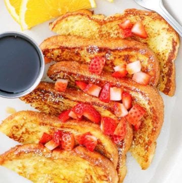 french toast with chopped strawberries on top.