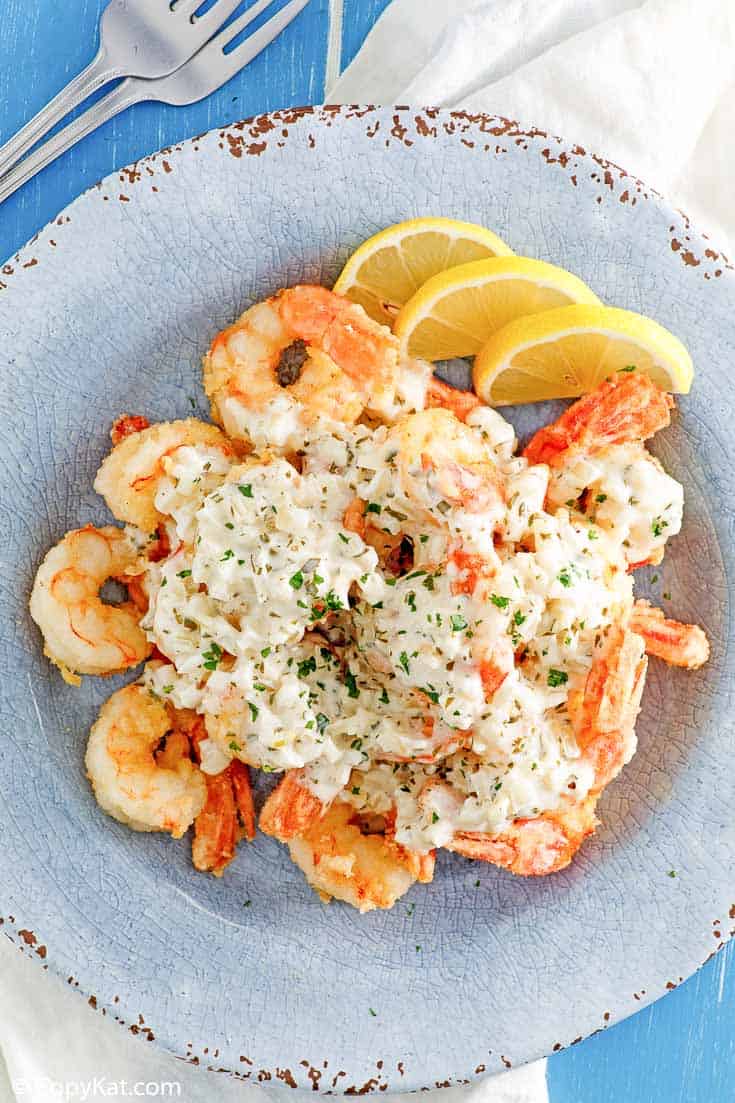 shirmp scampi fritta and lemon slices on a blue plate