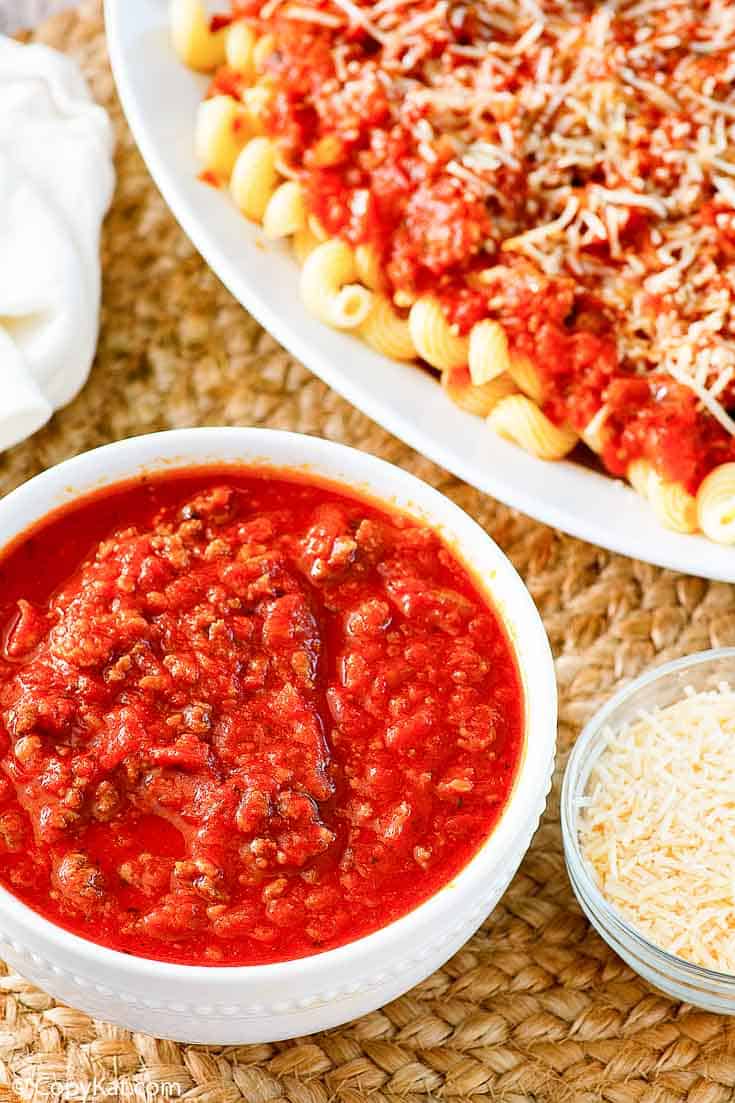 a bowl of three meat sauce and a plate of pasta with the sauce