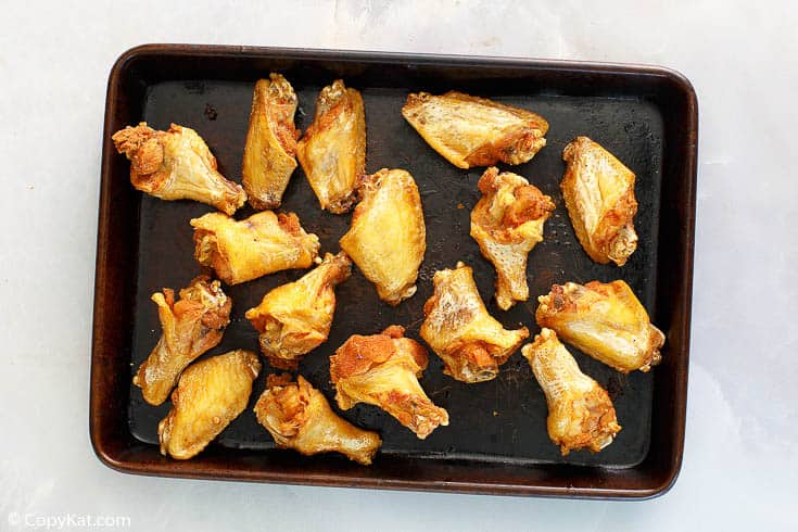crispy fried chicken wings on a baking sheet