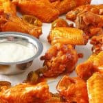 homemade Pluckers hot wings and dressing on parchment paper