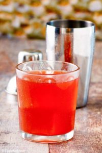 Washington Apple Cocktail in a glass with a shaker behind it