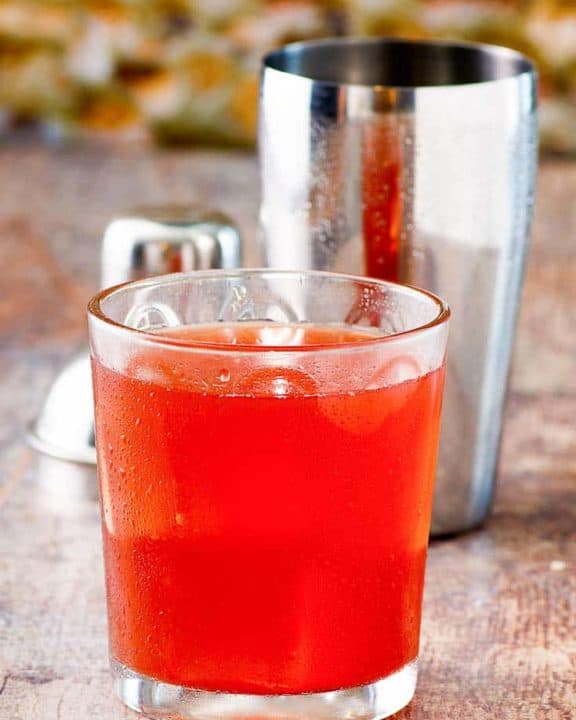 Washington Apple Cocktail in a glass with a shaker behind it