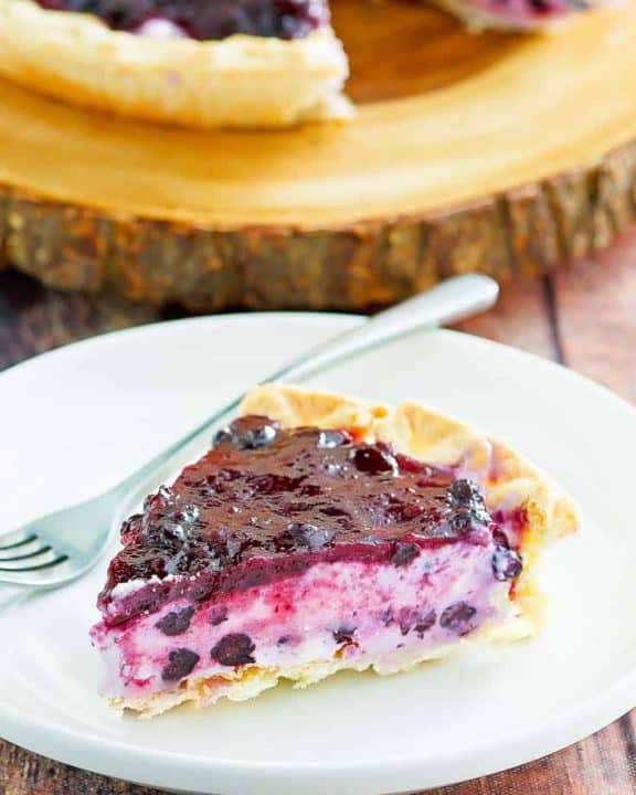 a slice of blueberry cream cheese pie on a white plate