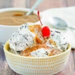 a bowl of ice cream topped with peanut butter sauce