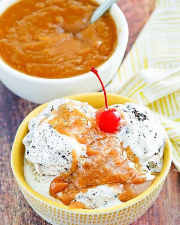 a bowl of cookies and cream ice cream with peanut butter sauce on top
