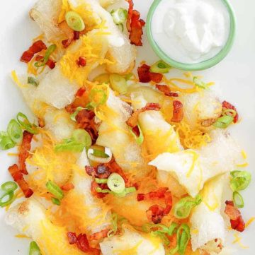 mashed potato spring rolls topped with bacon and cheese