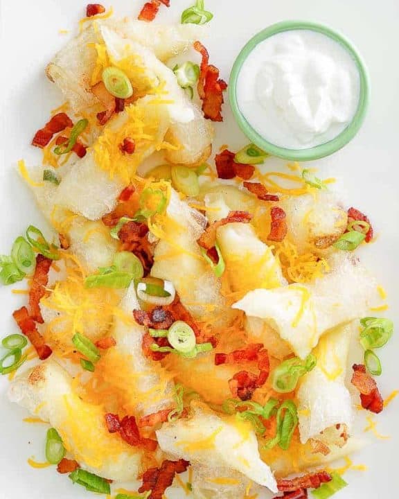 mashed potato spring rolls topped with bacon and cheese