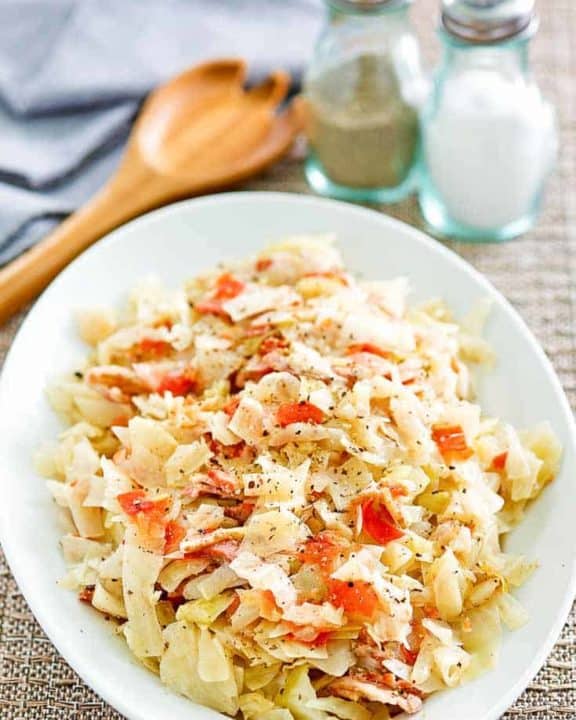 skillet cabbage with bacon on a white platter