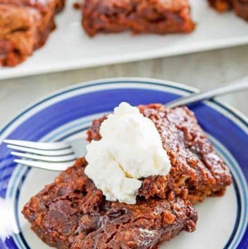 two slices of chocolate pudding cake topped with whipped cream