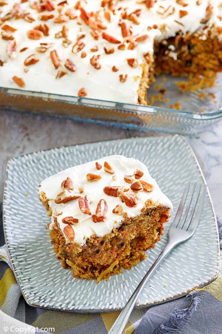 carrot cake with cream cheese frosting on a plate and in a baking dish