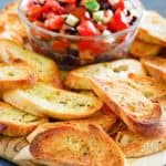 homemade crostini and a bowl of chopped tomato topping