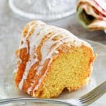 a slice of golden pound cake on a glass plate