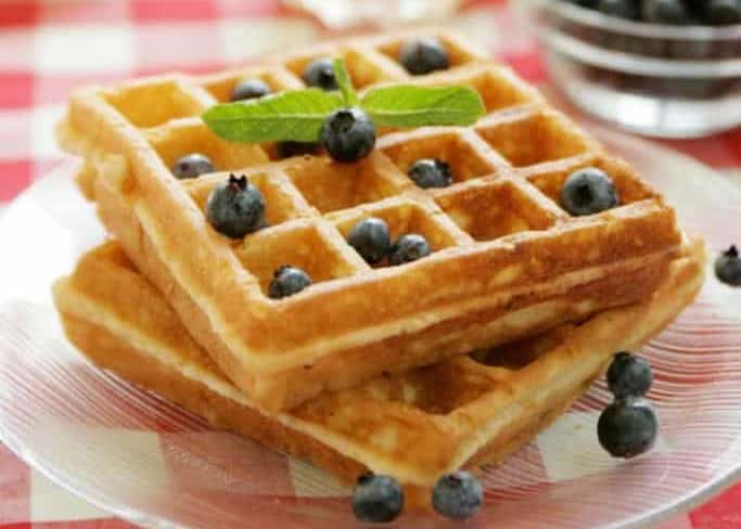 two waffles and blueberries on a plate