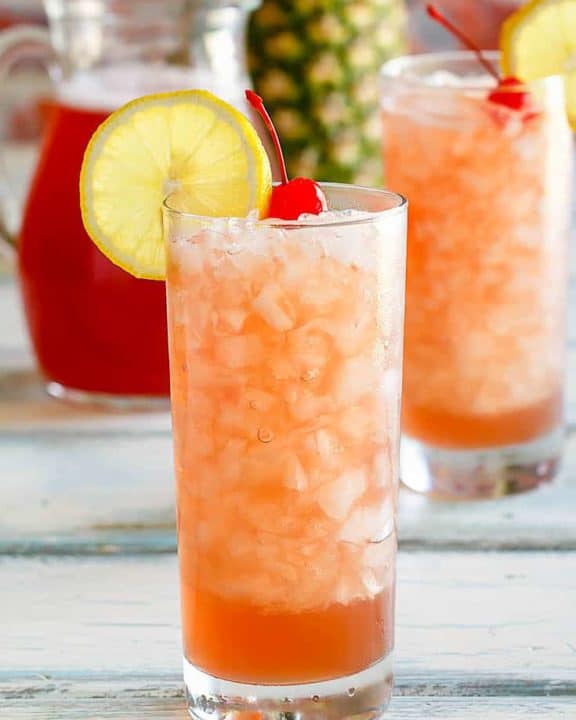 two glasses and a pitcher of homemade Joe's Crab Shack secret passion punch
