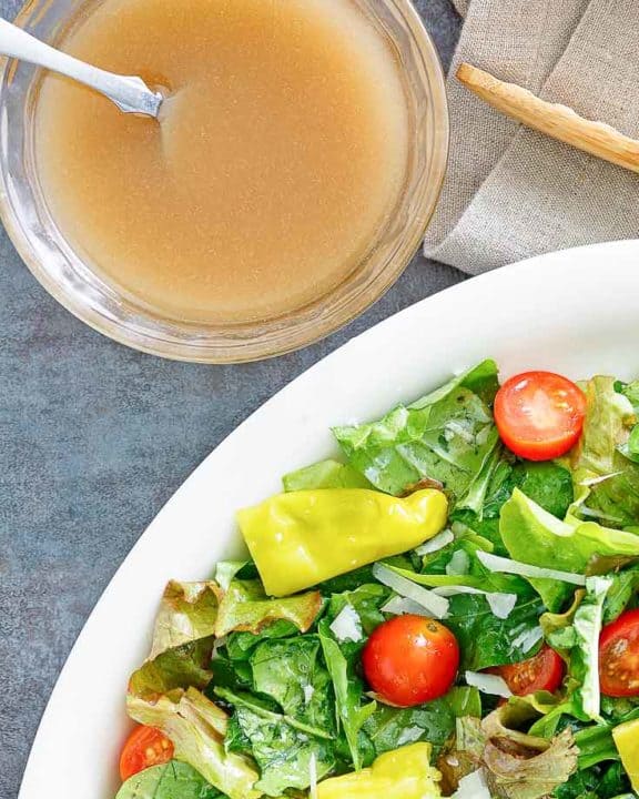 homemade Luigetta's salad dressing next to a salad