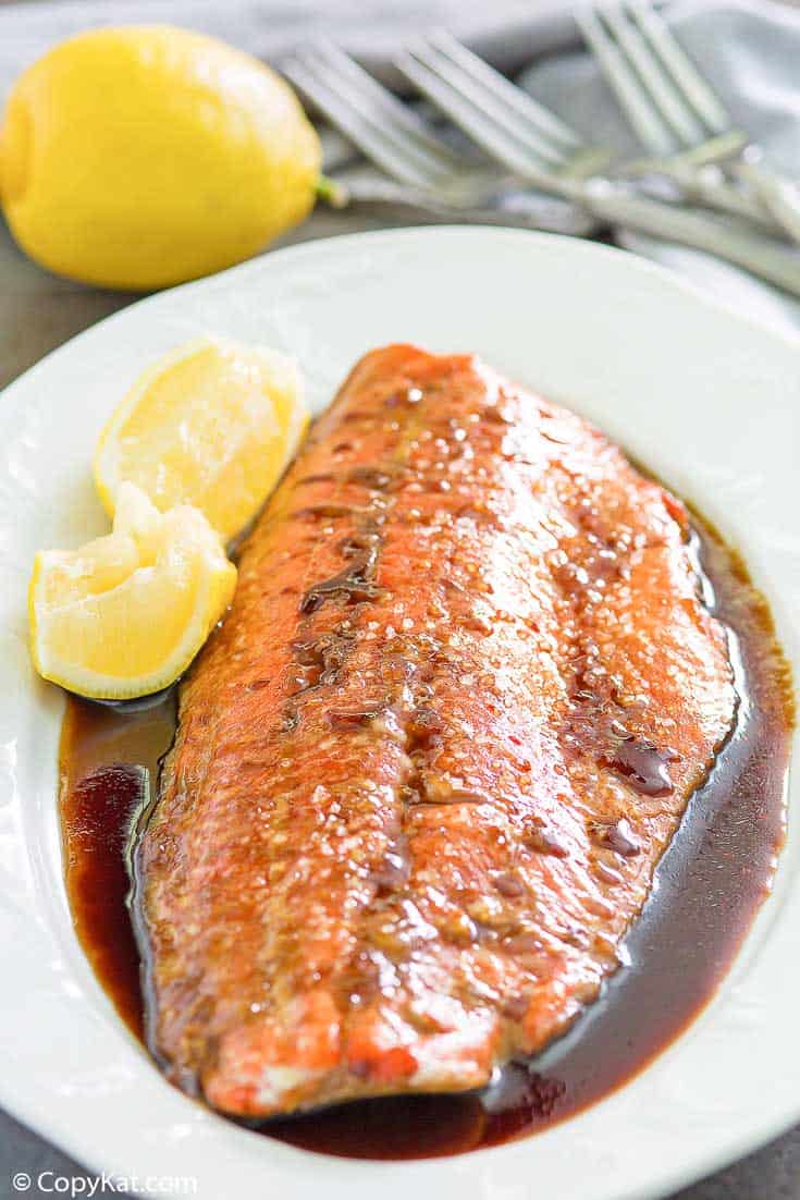 baked salmon with sauce on a platter