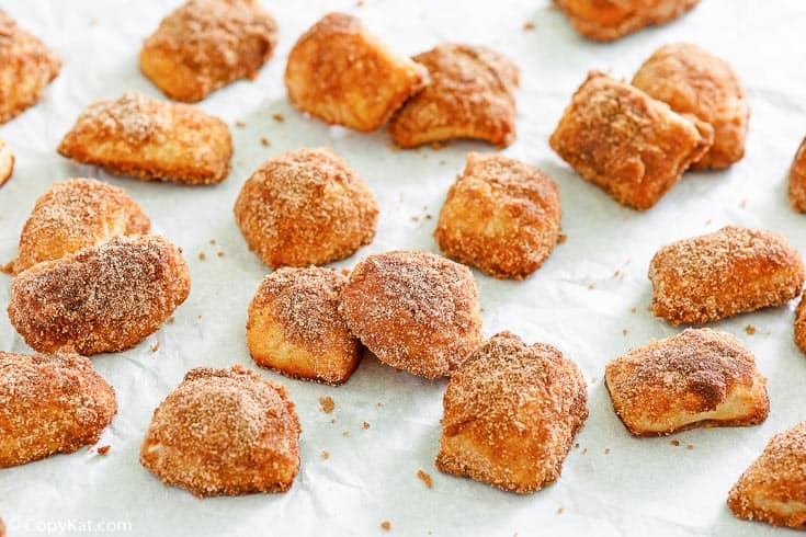 cinnamon sugar pretzel bites scattered on parchment paper