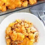 overhead view of hamburger tater tot casserole on a plate and in a baking dish