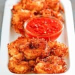 a platter of coconut fried shrimp and dipping sauce