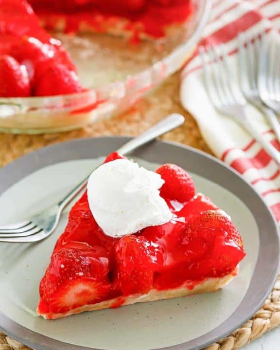 a slice of homemade Big Boy strawberry pie with a dollop of whipped cream on top