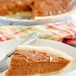 a slice of chocolate cream pie with the pie in the background