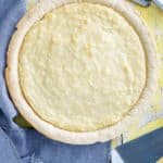 a whole coconut cream pie, forks, napkin, and pie server