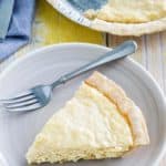 a slice of coconut cream pie and a fork on a plate