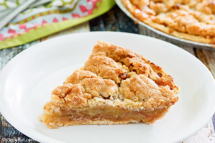 a slice of Dutch apple pie on a white plate