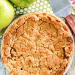 a whole Dutch apple pie, green apples, and a pie server