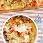 overhead view of hot German potato salad in a bowl and baking dish