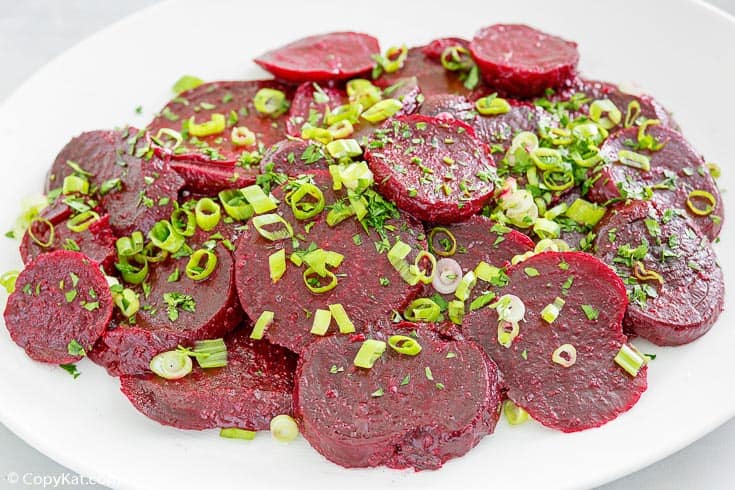 marinated beet salad topped with green onions