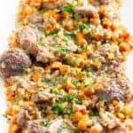 beef shanks and vegetables on a platter