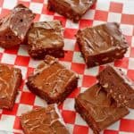 overhead view of chocolate frosted brownies on parchment paper
