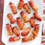 overhead view of bacon wrapped little smokies on a platter