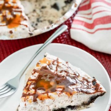 a slice of ice cream pie with toffee and chocolate chips and Oreo crust