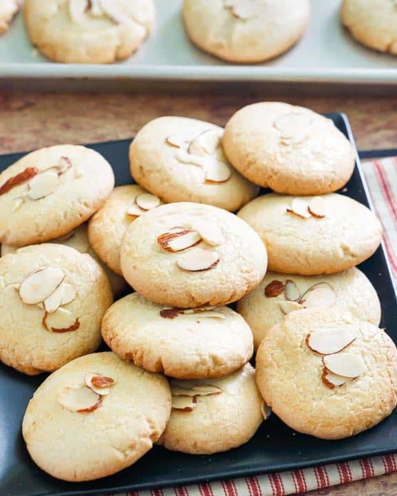 Chinese almond cookies on a platter and baking sheet
