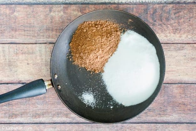 Ingredients for homemade Hershey's chocolate syrup in a skillet