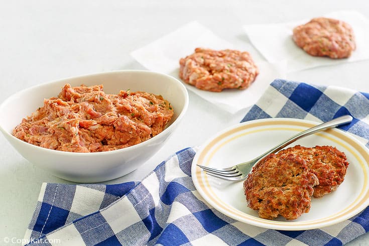 homemade Italian sausage patties and raw mixture in a bowl