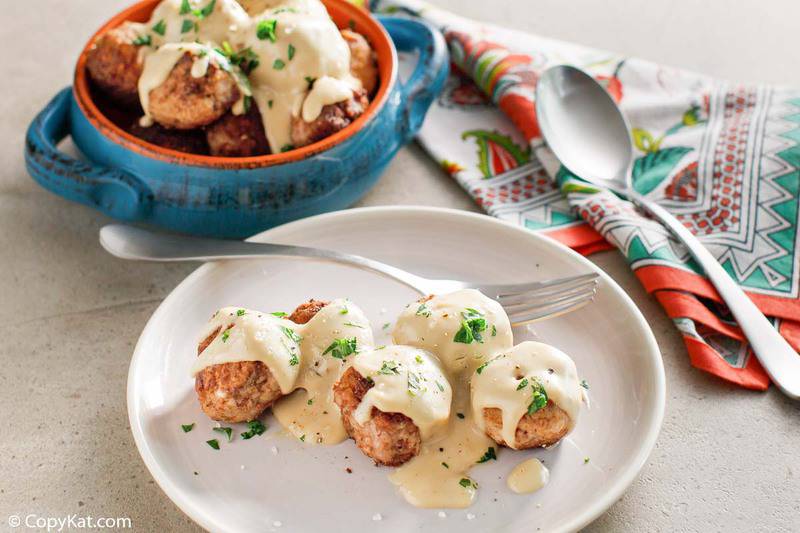 Swedish meatballs and gravy on a plate and in a bowl