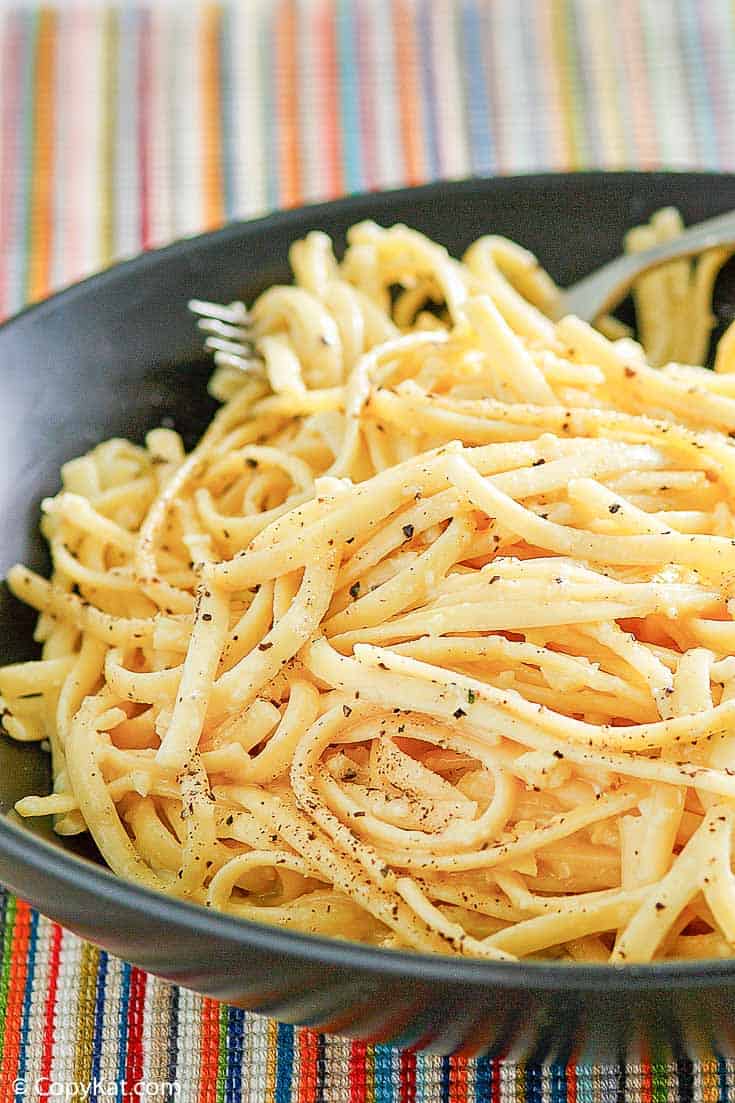 pasta with egg and cheese in a black bowl