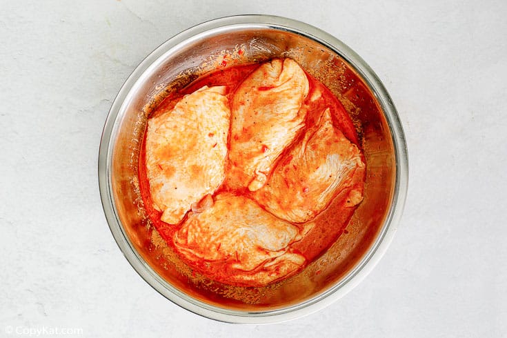 chicken thighs and Peruvian marinade in a bowl