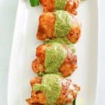 Peruvian chicken with fresh green sauce on a platter