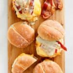 overhead view of homemade Wendy's breakfast baconator sandwiches on a wood board