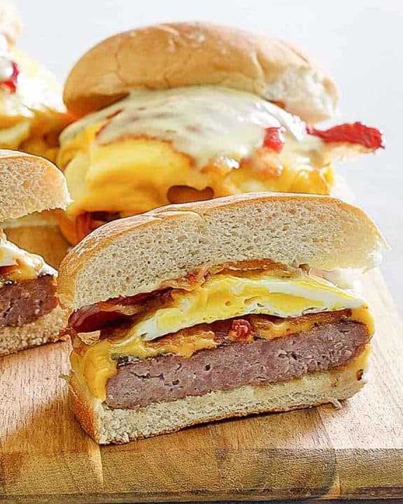 homemade Wendys Breakfast Baconator Sandwiches on a wood board